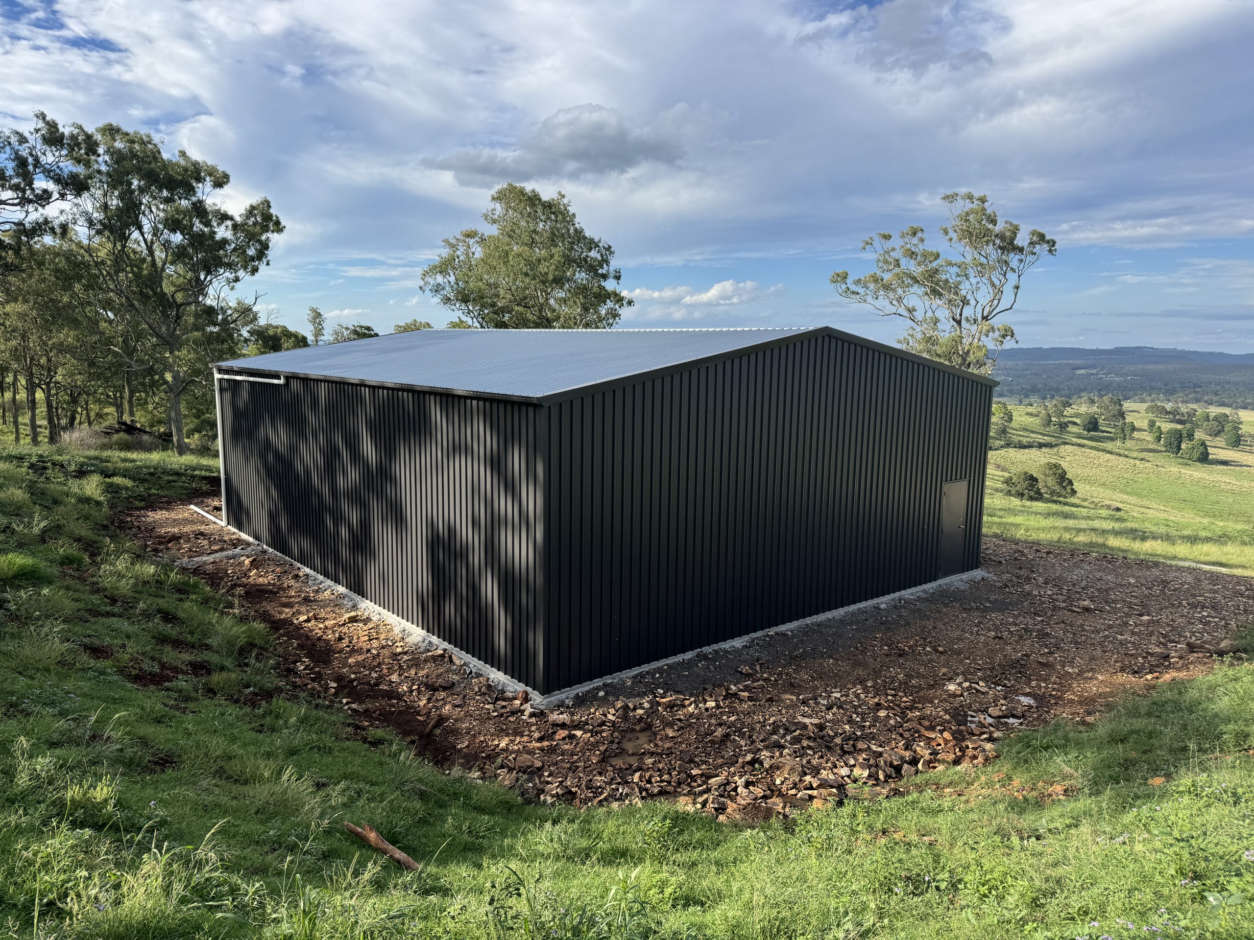 Triple garage shed front view — COLORBOND Monument with zinc roof